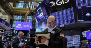 Pantallas de cotizaciones bursátiles de Wall Street en verde y mapa del estrecho de Ormuz